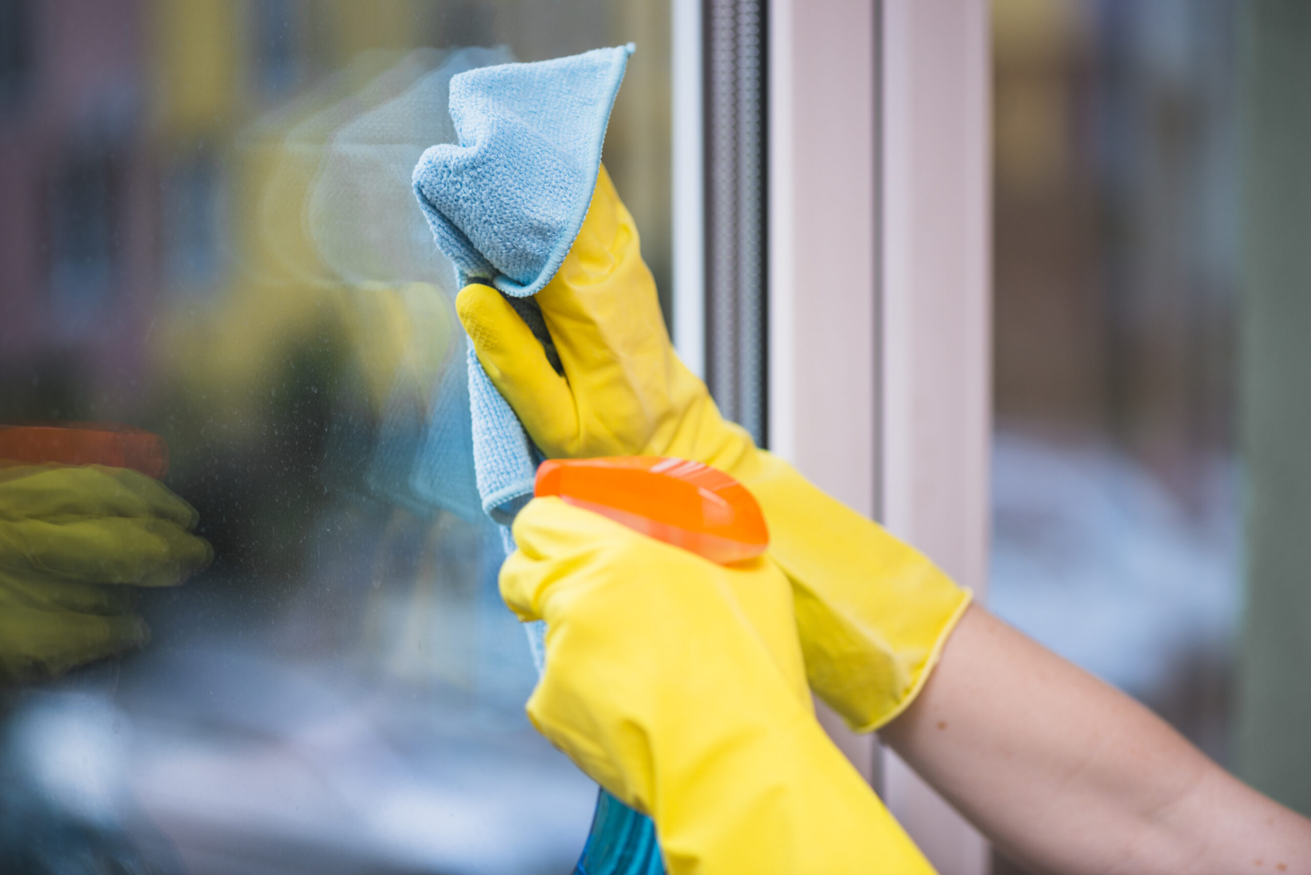 janitor-s-hand-cleaning-glass-window-with-cloth